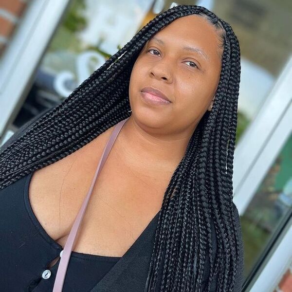 Medium Knotless Box Braids - a woman wearing a black dress