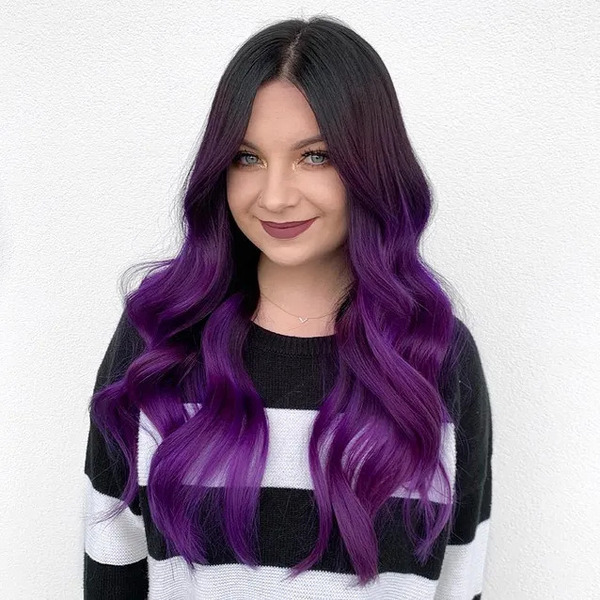 Melted Dark Purple in Wavy Hair - a woman wearing a sweat shirt