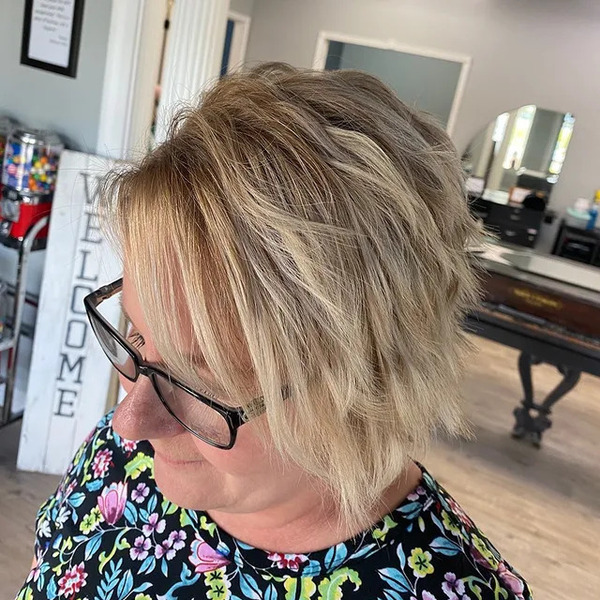 Messy Bob Cut with Crimped Hair - a woman wearing an eyeglasses