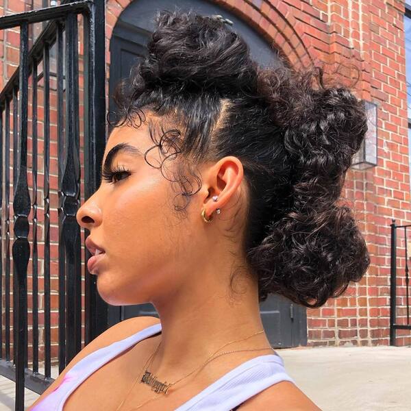 Messy Bun Mohawk Baddie Hairstyle - a woman in a side view