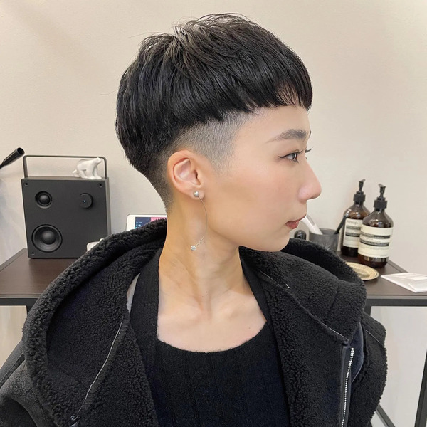 Mushroom Cut with Chopped Black Hair -a woman wearing a black jacket