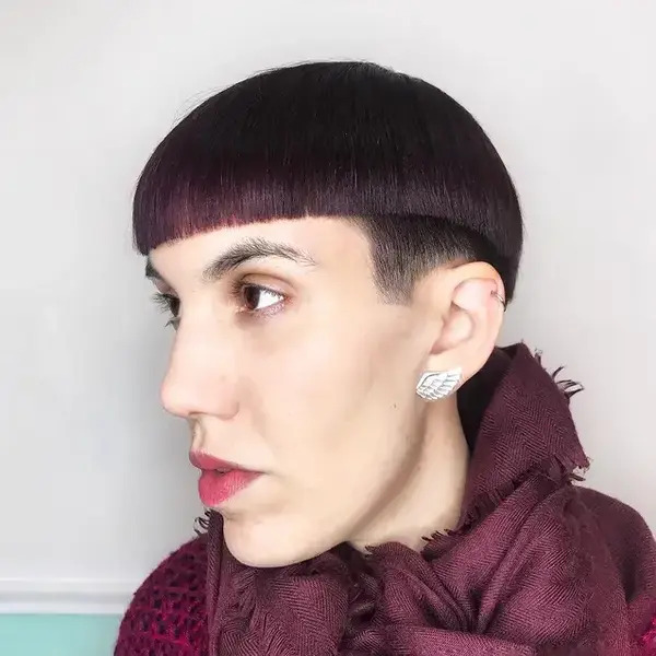 Edgy Bob with Shaved Undercut - a woman wearing a violet dress
