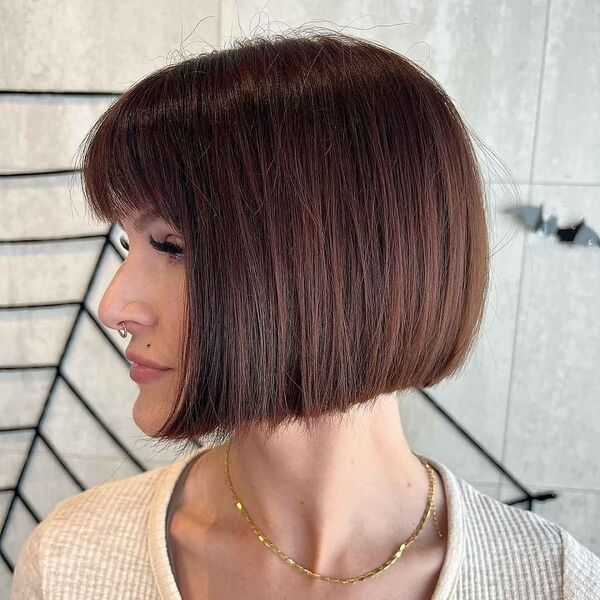 One-Length Blunt Cut with Fringe - a woman in a side view