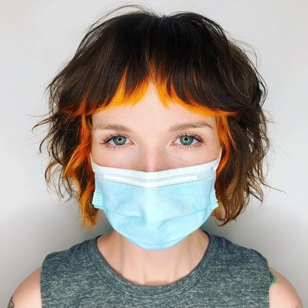 Orange Peek-a-Boo on French Razor Bob - a woman wearing a face mask