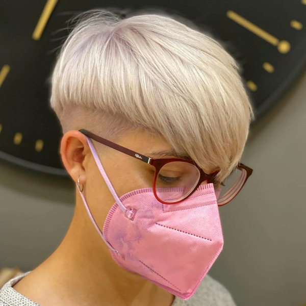 Platinum Mushroom Cut with V-Shape Bangs - a woman wearing a pink face mask