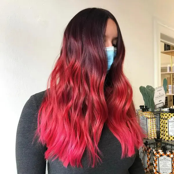 Raspberry Ombre Hair - a woman wearing a facemask