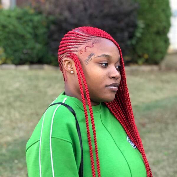 Red Lemonade Braids - a woman wearing a green jacket