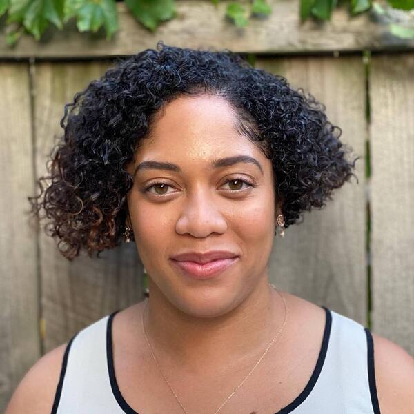 Short Bob Hairstyle and Coils - a woman wearing a white sleeveless