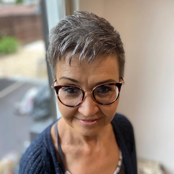 Short and Sassy Pixie Haircuts for Older Women- a woman wearing a face mask
