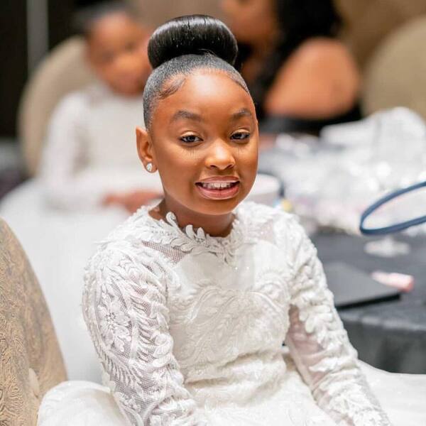 Simple Slicked Bun - a girl wearing a white dress