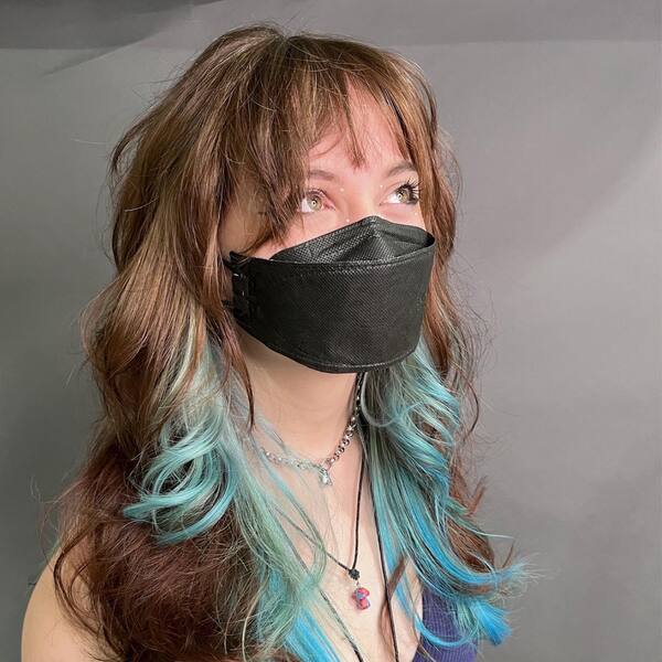 Icy Blue Underlights for Shaggy Haircut - a woman wearing a black face mask