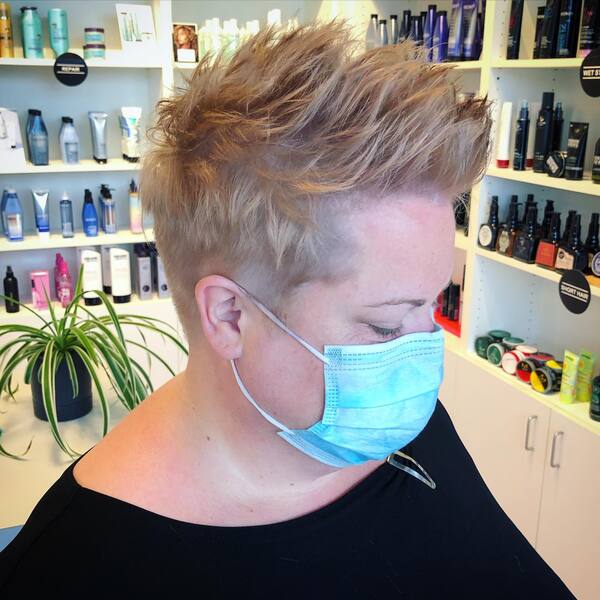 Spiky Pompadour Hairstyle - a woman wearing a face mask