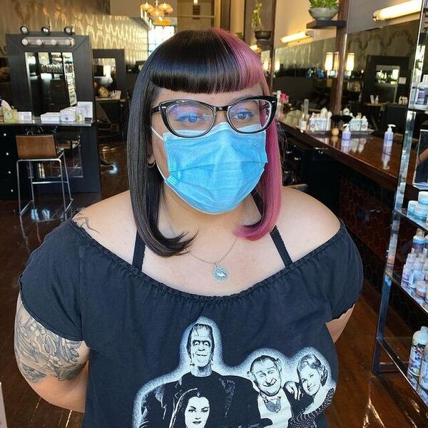 Split Dye and Bang Trim - a woman wearing a face mask