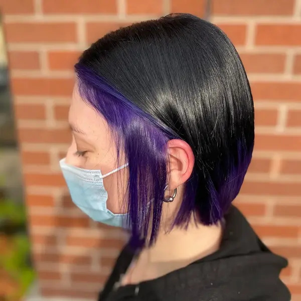 Straight Bob with Purple Underlights - a woman wearign a face mask
