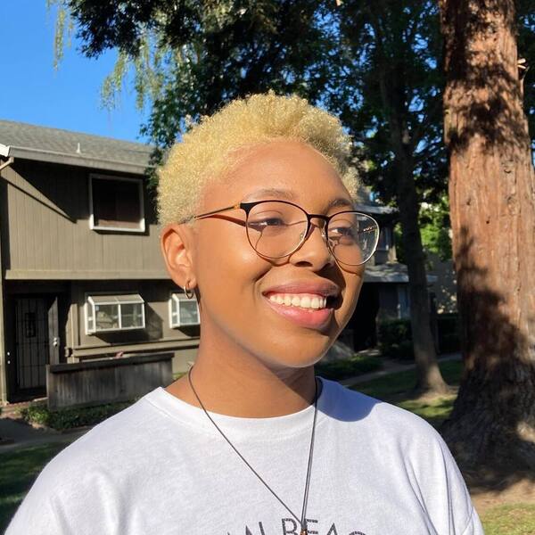 Summer Cut and Blonde - a woman wearing a white shirt