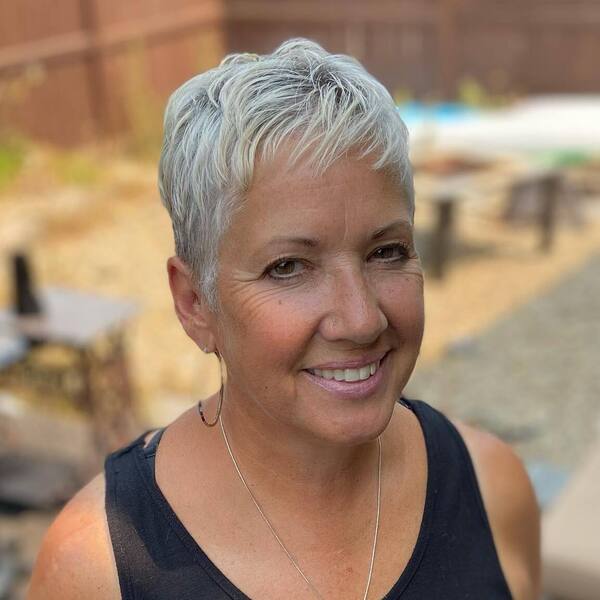 Summer Pixie Haircuts for Older Women with Platinum Color - a woman wearing a sleeveless
