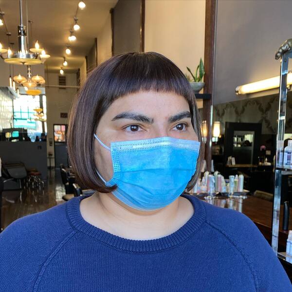 Super-Mini Fringe and French Inspired Bob - a woman wearing a face mask