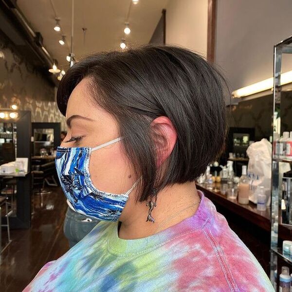 Textured Bob Haircut - a woman wearing a face mask