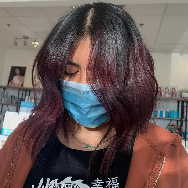 Textured Bob and Burgundy Ombre Hair - a woman wearing a face mask