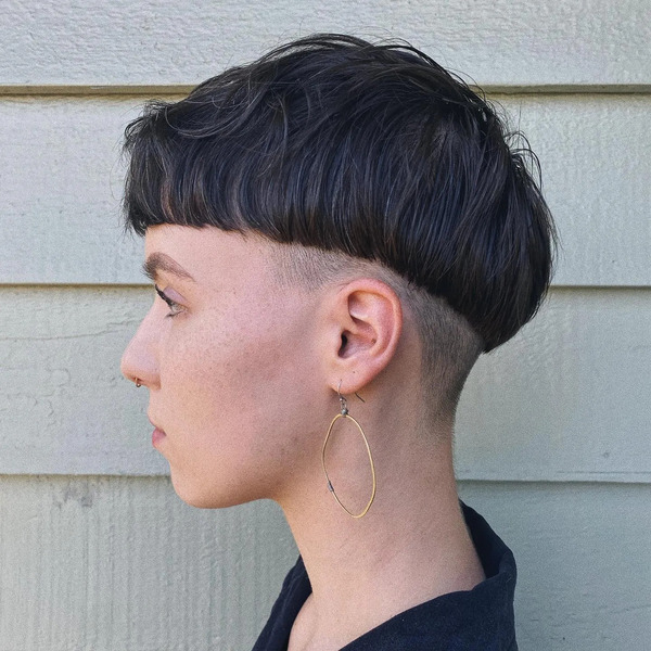 Textured Sharp and Edgy Mushroom Cut - a woman wearing an earrings