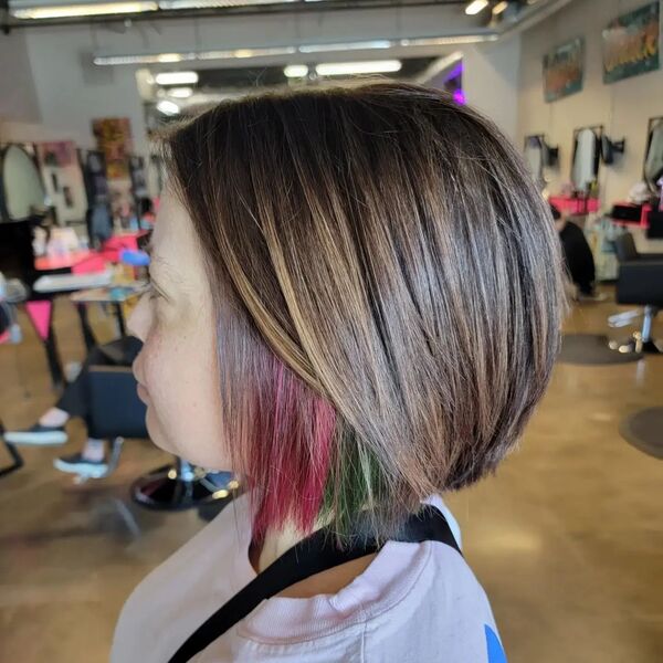 Tri-Color Peek-a-Boo Hairstyle - a woman wearing a pink shirt