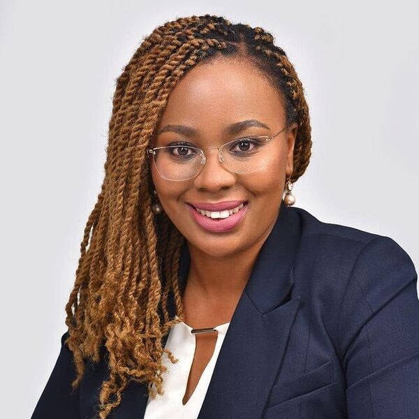 Twist Braids with Honey Blonde - a woman wearing a formal attire