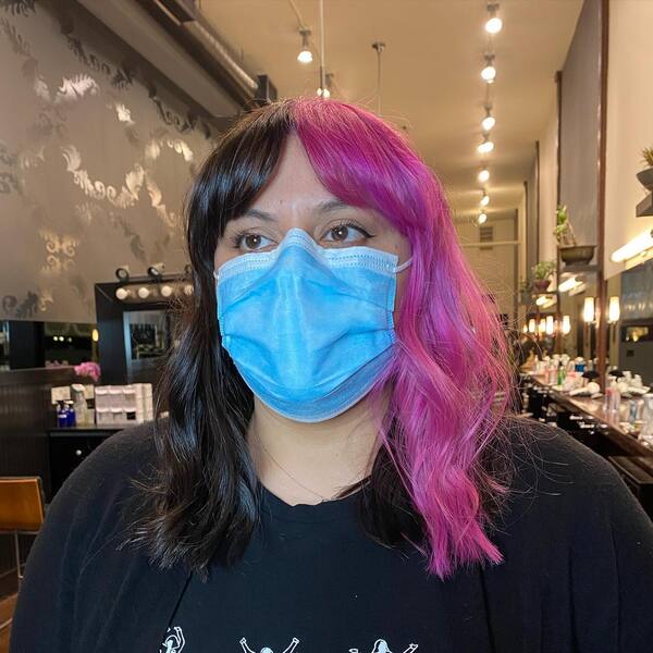 Two-Toned Split Bangs - a woman wearing a face mask