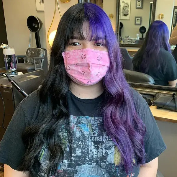 Two Toned Wavy Hair with Chopped Bangs - a woman wearing a pink face mask