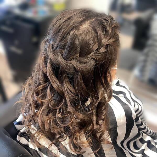 Waterfall Braids Style - a girl wearing a striped barber's cape