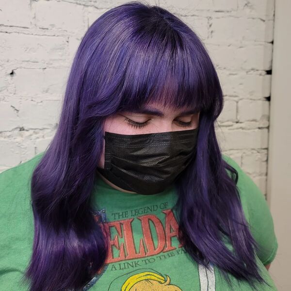 Wavy Midnight Purple Hair - a woman wearing a black face mask