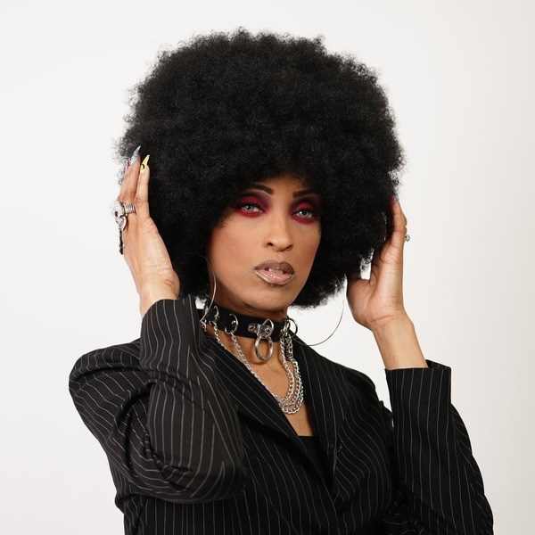 Afro Kinky Ball Hair - a woman wearing black coat with accessories