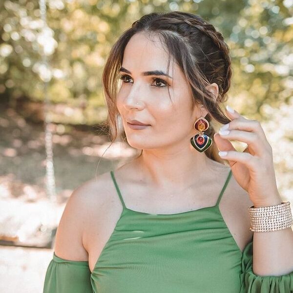 Braided Ponytail with Side Bangs - a woman wearing green sexy top