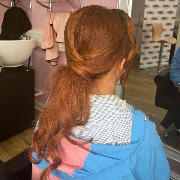 Copper Twisted Pony with Bangs - a woman wearing blue jacket