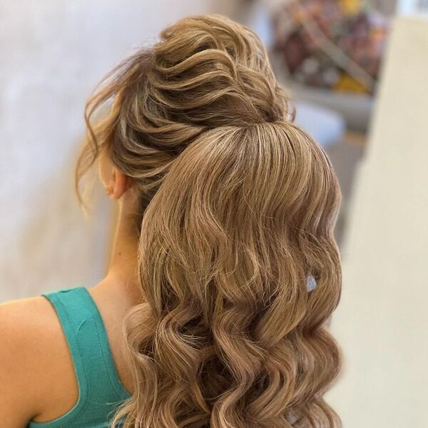 Dimensional Pomp Ponytail with Bangs - a woman wearing blue green top