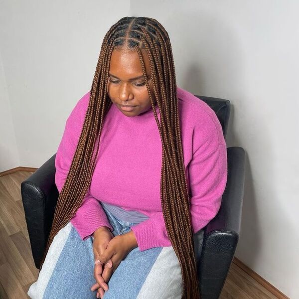 Extra Long Box Braids - a woman wearing pink sweater