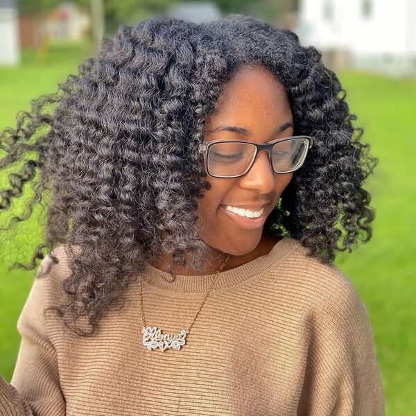 Layered Parted Kinky Hair - a woman wearing brown sweater and glasses