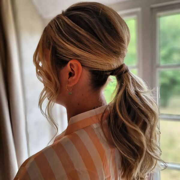 Pomp Ponytail with Curled Bangs - a woman wearing stripe polo