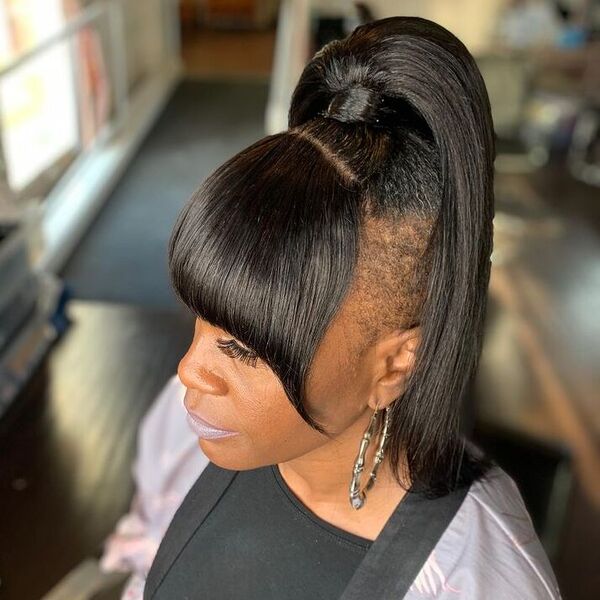 Ponytail Undercut with Bangs - a woman wearing black top