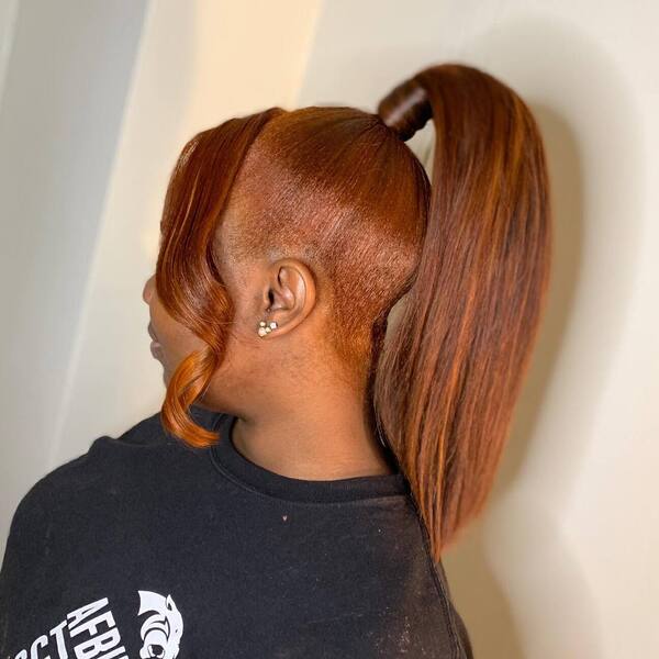 Short Ponytail with Bangs in Copper - a woman wearing black printed shirt