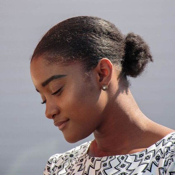 Simple Low Bun - a woman wearing white printed top