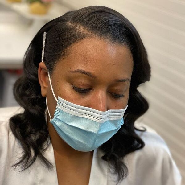 Swept Curly Bridal Hair - a woman wearing silk robe with mask