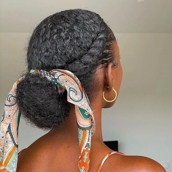 Twisted Crown Bun - a woman wearing gold earrings