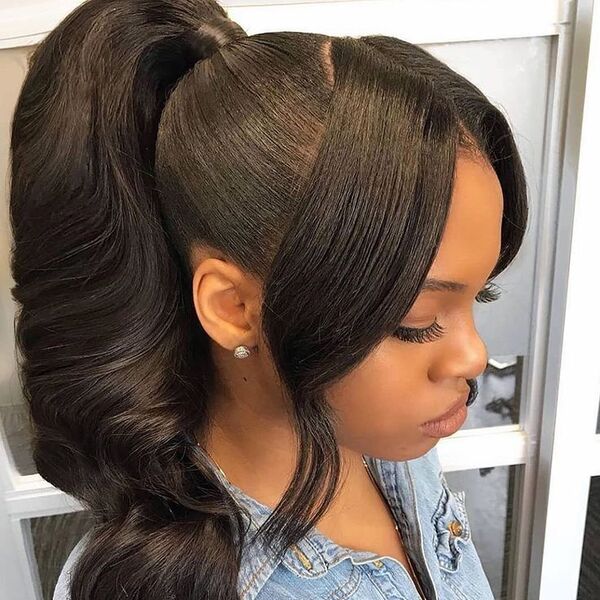 Wavy Ponytail with Parted Bangs - a woman wearing blue denim jacket