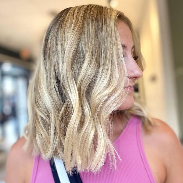 Blunt Long Bob Blonde - a woman wearing pink halter top