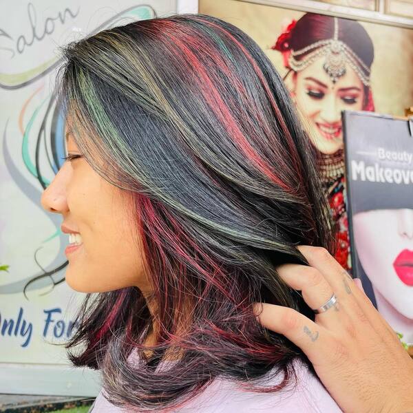 Bouncy Long Bob with Colorful Highlights - a woman wearing pink shirt