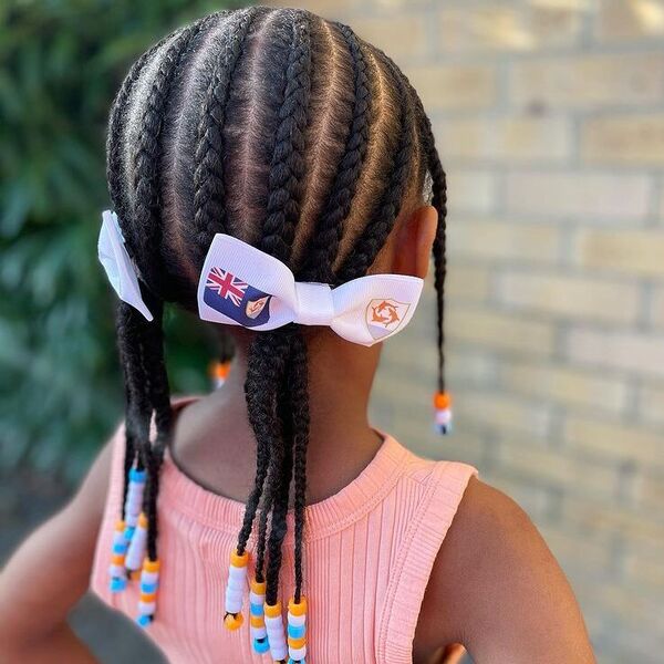 Braids in Low Ponytail with Beads - a girl is wearing peach top