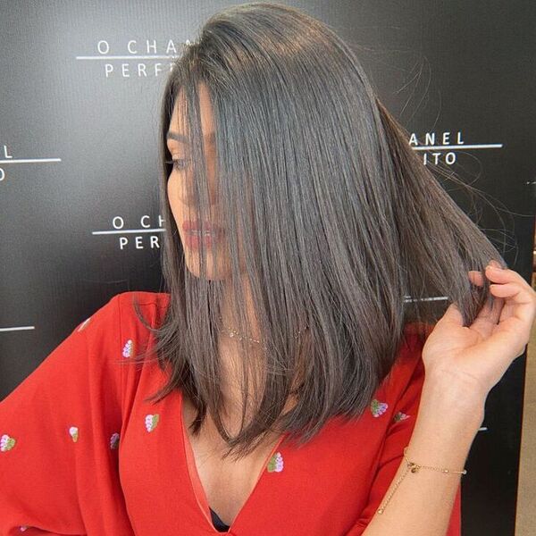 Chic Swept Long Bob - a woman wearing red top