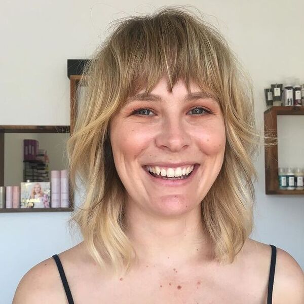 Choppy Fine Bob with Bangs - a woman wearing black tank top