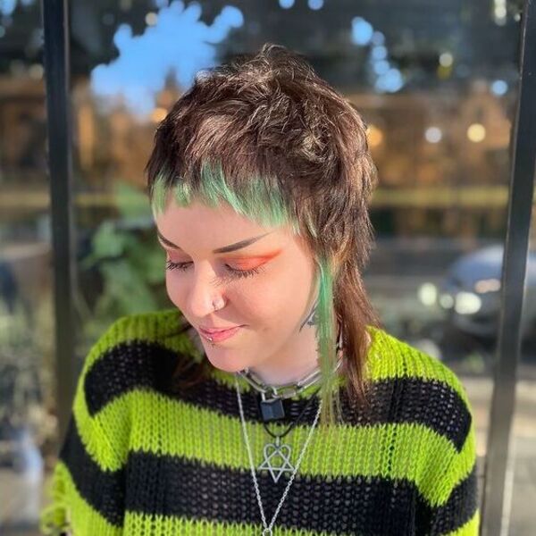 A woman wearing green black knitted sweater