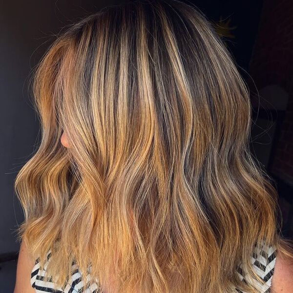 Chunky Strawberry Blonde Long Bob - a woman wearing stripe top